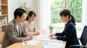不動産売却について相談する夫婦と担当スタッフ